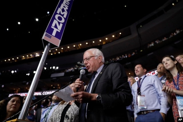 Former Democratic presidential candidate, Sen. Bernie Sanders, I-Vt., stands with the Vermont delegation and asks that Hillary Clinton become the unanimous choice for President of the United States during the second day of the Democratic National Convention.