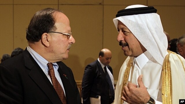 Libyan Finance Minister Nagib Mustafa al-Serraj, left, talks with Yousef Hussain Kamal, Qatar Finance Minister, at the opening of Arab Finance Ministers Exceptional meeting in Abu Dhabi, United Arab Emirates, September 7, 2011.