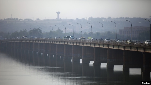 Vehicles cross on a bridge in the Malian capital of Bamako, January 12, 2013.
