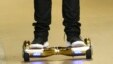 FILE - Seattle Seahawks wide receiver B.J. Daniels rides a hoverboard as he arrives for an NFL football game against the Carolina Panthers, in Seattle. Amazon is warning British customers that their hoverboards may be unsafe, the latest in a string of war