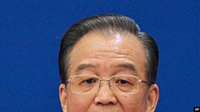 Chinese Premier Wen Jiabao gestures as he answers questions during a press conference after the closing session of the annual National People's Congress in Beijing's Great Hall of the People Monday, March 14, 2011.
