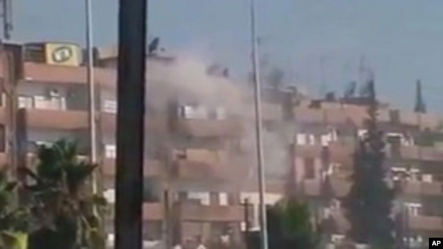 August 3 image from mobile video shows smoke rising from a building in the Al Hader area of Hama (third party image; content cannot be independently confirmed by Reuters)