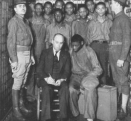 Defense attorney Samuel Leibowitz meets with his clients in Scottsboro, Alabama (1933).