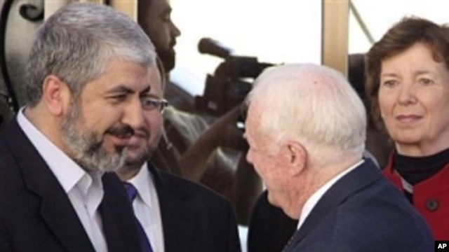 Hamas leader Khaled Mashaal, left, shakes hands with former U.S. President Jimmy Carter as former Irish President Mari Robinson, right, looks on in Damascus, Syria, Tuesday, Oct. 19, 2010