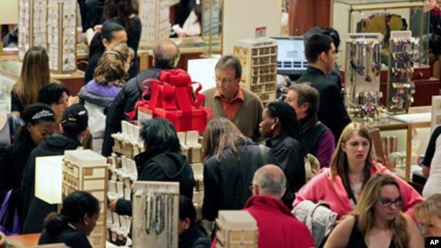 Macy's aisles are crowded with shoppers on Black Friday - called that because the surge of shoppers could take retailers into profitability, Manhattan, 26 Nov. 2010