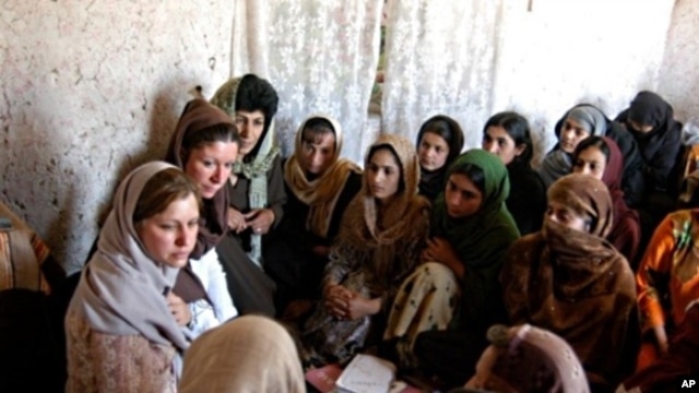 Susan Retik Ger and Patti Quigley visit a literacy class in Afghanistan.