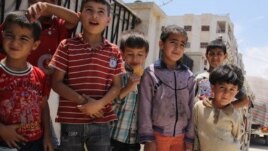 Syrian boys at camp for displaced in Aleppo