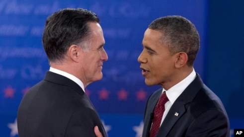 President Barack Obama and Republican presidential candidate Mitt Romney greet each other as they arrive for the presidential debate, October 16, 2012.