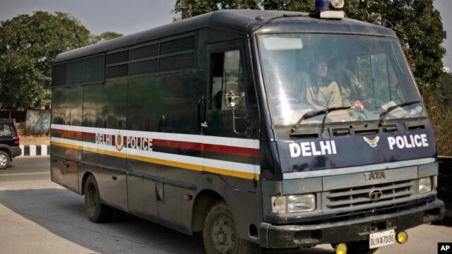 A police van carrying five of the six men accused in the gang rape and murder of a 23-year-old woman enters a district court in New Delhi, India, January 24, 2013. 