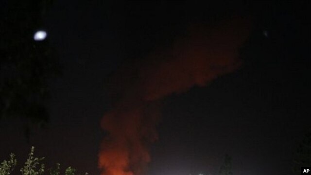 A plume of smoke and fire is seen after an airstrike in Tripoli, Libya, June 14, 2011.