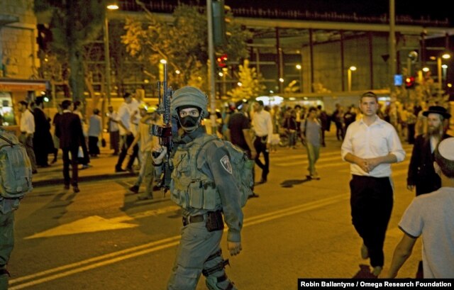 FILE - An Israeli special forces soldier walks outside the Central Jerusalem Bus Station after police said a woman was stabbed by a Palestinian outside the bus station, October 14, 2015.