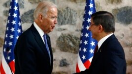 U.S. Vice President Joe Biden, left, shakes hands with Turkish Prime Minister Ahmet Davutoglu, right, following a joint news conference after their meeting in Dolmabahce Palace in Istanbul, Jan. 23, 2016.