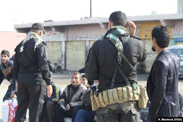 Men fleeing IS appear very much like the militants as they run, having been forced to grow beards and wear IS-style clothing in Gogjali, Mosul, Iraq, Nov. 7, 2016.