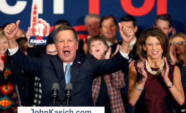 With his wife Karen at his side Republican presidential candidate Ohio Gov. John Kasich cheers with supporters, Feb. 9, 2016, in Concord, N.H., at his primary night rally.
