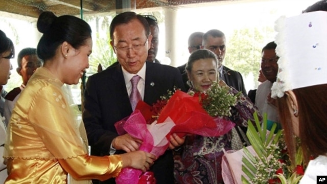 U.N. Secretary-General Ban Ki-moon, center left, and his wife Yoo Soon-taek, center right, receive flowers from a staff upon their arrival at a hotel Sunday, April 29, 2012 in Yangon, Burma.