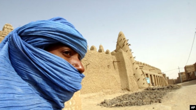 A Tuareg nomad stands near the 13th century mosque at Timbuktu, Mali (file photo).