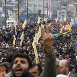 Demonstrators march with yellow BDP flags and display outlawed PKK banners during a protest against the election board's decision in Istanbul, April 19, 2011