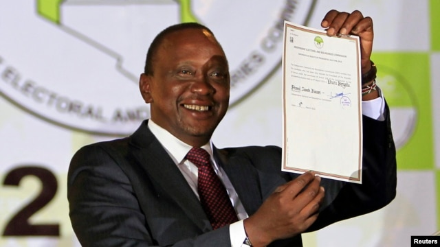 President-elect Uhuru Kenyatta displays the certificate from Independent Electoral and Boundaries Commission (IEBC) declaring him the winner of the country's presidential election in Nairobi, March 9, 2013. 