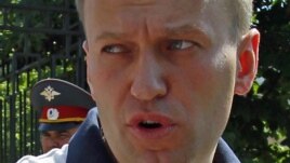 Prominent anti-corruption blogger and opposition leader Alexei Navalny speaks to the media after leaving the Investigative Committee of the Russian Federation in Moscow, July 31, 2012.