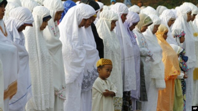A Muslim boy prays during Eid al-Fitr prayer that marks the end of the holy fasting month of Ramadan in Jakarta, Indonesia, Aug. 30, 2011.