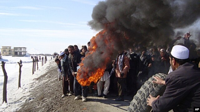 Afghans burn tires during an anti-U.S. demonstration over burning of Qurans at a US military base, in Muhammad Agha, Logar province south of Kabul, Afghanistan, February 25, 2012.