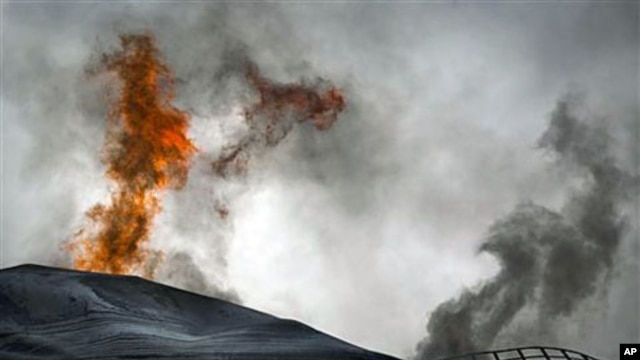 A fuel tank of a power station burns on the outskirts of the city of Ajdabiya, south of Benghazi, eastern Libya, March 21, 2011