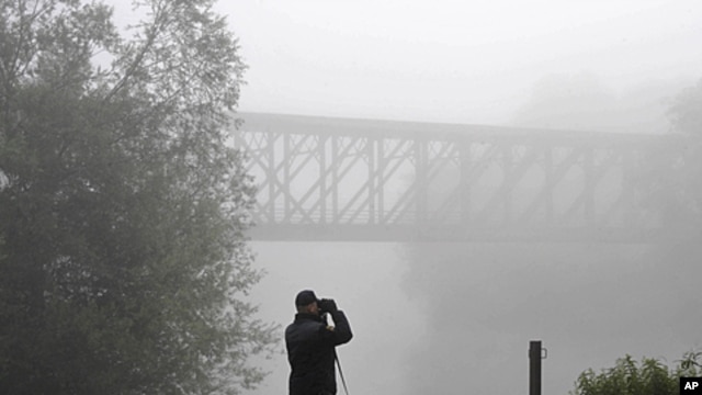 A member of the border police searches for illegal migrants on a railway bridge at the Schengen border with Croatia, June 20, 2011.