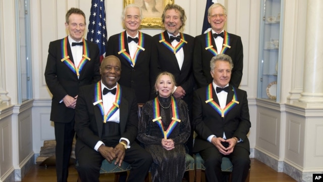 The 2012 Kennedy Center Honorees, from left, John Paul Jones, Buddy Guy, Jimmy Page, Natalia Makarova, Robert Plant, Dustin Hoffman, and David Letterman pose for a group photo, December 1, 2012 at the State Department in Washington.