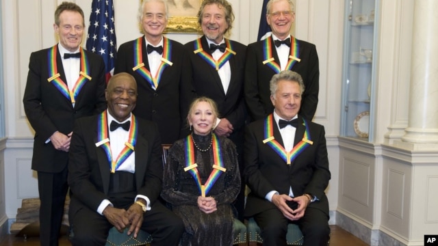 The 2012 Kennedy Center Honorees, from left, John Paul Jones, Buddy Guy, Jimmy Page, Natalia Makarova, Robert Plant, Dustin Hoffman, and David Letterman pose for a group photo Dec. 1, 2012 at the State Department in Washington.