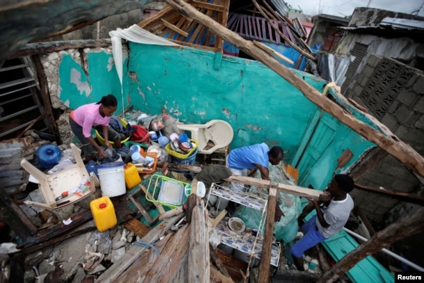 Residents work clearing a house destroyed by Hurricane Matthew in Les Cayes, Haiti, October 5, 2016.