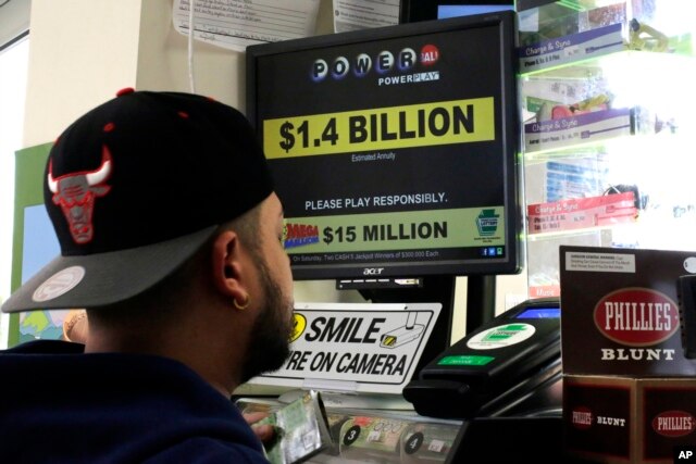 A man buys Powerball tickets at a convenience store in Lancaster, Pa., Jan. 11, 2016.