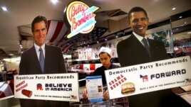Life-sized standees of U.S. President Barack Obama, right, and Republican presidential candidate and former Massachusetts Gov. Mitt Romney decorate the entrance of American Diner chain in Singapore, "Billy Bombers" November 6, 2012. 