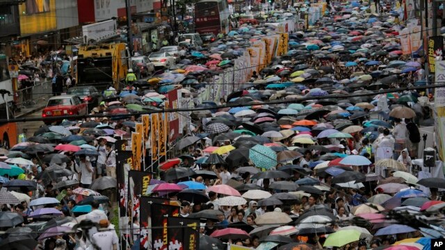 Người biểu tình ồ ạt xuống đường trong trời mưa ở Hong Kong, ngày 1/7/2014. 