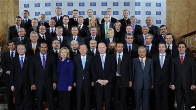 Delegates attending the London Conference on Libya, pose for a group photo at Lancaster House in London, Tuesday March 29, 2011.
