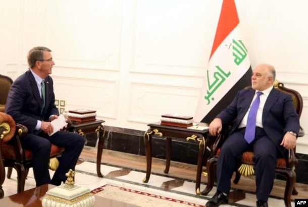 A handout picture released by the Iraq prime minister's press office shows Iraqi Prime Minister Haidar al-Abadi, right, meeting with U.S. Secretary of Defense Ash Carter in Baghdad, Oct. 22, 2016.
