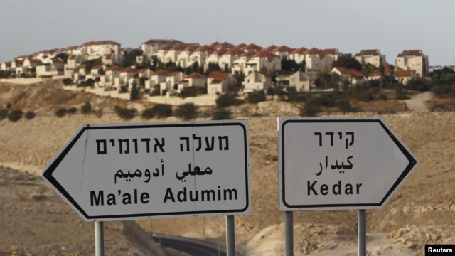 The West Bank Jewish settlement of Maale Adumim, near Jerusalem, is seen behind sign posts December 3, 2012. 