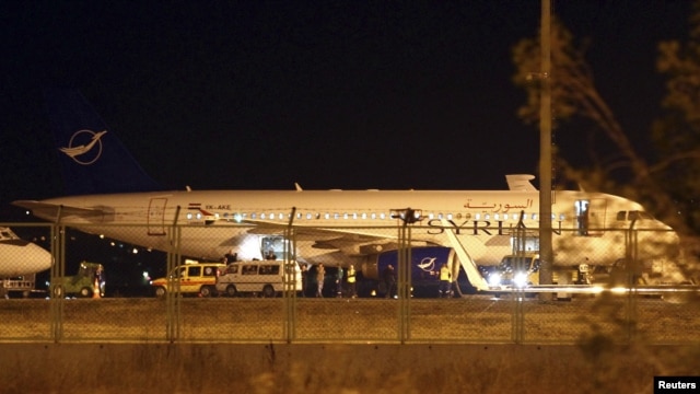 A Syrian passenger plane, which was forced to land, sits at Esenboga airport in Ankara October 10, 2012.