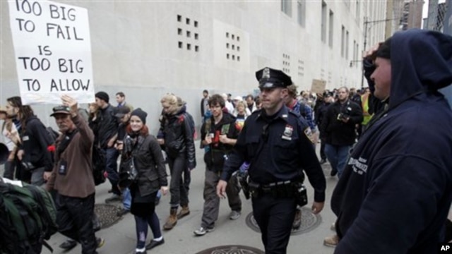 'Occupy Wall Street' protesters march to a Verizon office to support employees there who are picketing in New York, Tuesday, Oct. 4, 2011.
