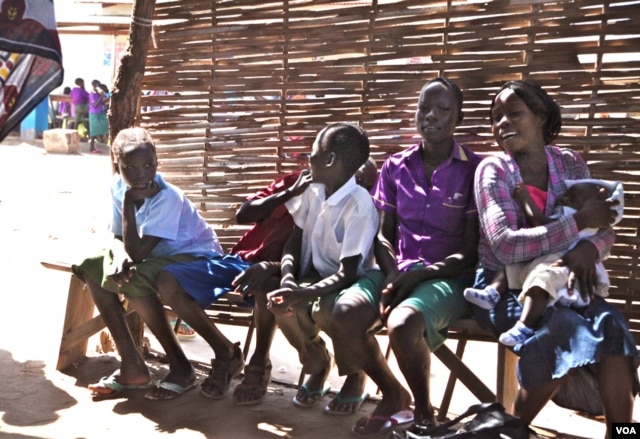 Children wait for their mothers at the Antenatal Clinic in South Sudan. (VOA - H. McNeish)