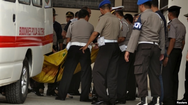 Police carry body bags — one of which is believed to contain the remains of Santoso, the country's most wanted militant, killed in a clash with security forces — from an ambulance at a hospital in Palu, Central Sulawesi, Indonesia, July 19, 2016.