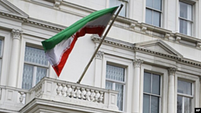 British police stand guard outside the Iranian Embassy in London. Britain's foreign secretary on Wednesday ordered all Iranian diplomats out of the U.K within 48 hours following attacks on the British embassy and a residential compound in Tehran, November