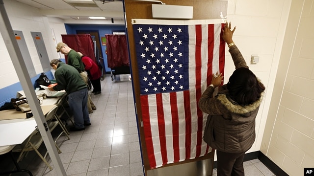 Election workers set up voting booths at Memorial Elementary School in Little Ferry, New Jersey, Nov. 6, 2012. 