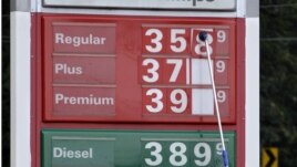 A man changes fuel prices at a ConocoPhillips gas station in Little Rock, Ark. The price of oil fell to its lowest point in nearly two months. U.S. consumer confidence slow, encouraging, Sept. 26, 2012