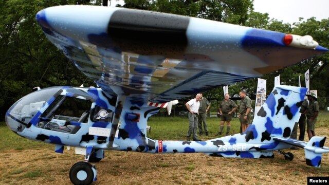 Rangers look at an anti-poaching aircraft named Seeker, which is being shown to reporters at the Kruger National Park in South Africa, December 4, 2012.