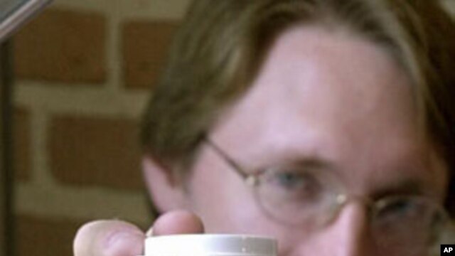 Kevin Ausman, executive director of the Rice University center for biological and environmental nanotechnology holds a bottle of carbon nanotubes.  Nanotechnology is  supposed to make computers small enough to implant into a wrist and supply materials tha