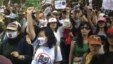 Chinese demonstrators shout slogans during a protest against a planned refinery project in downtown Kunming in southwest China's Yunnan province, May 16, 2013. 