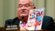 U.S. Representative Billy Long holds up a magazine with an Ebola headline at a House Energy and Commerce Oversight and Investigations Subcommittee hearing.