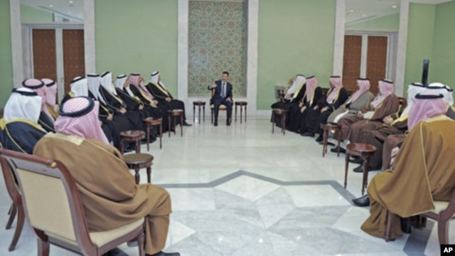 Syria's President Bashar al-Assad (C) meets a delegation of clan leaders from three cities in nation's northeastern region - Deir Ezzour, Raqqa and Hasaka - in Damascus, Syria, December 22, 2011.