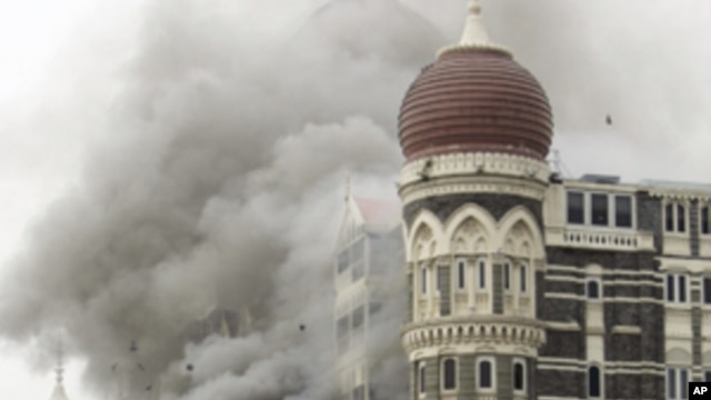 In this Saturday, Nov. 29, 2008 file picture, smoke billows from the landmark Taj Mahal hotel in Mumbai, India after an attack by gunmen