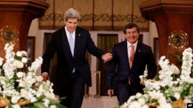 Secretary of State John Kerry, left, enters a news conference with Turkish Foreign Minister Ahmet Davutoglu in Ankara, Turkey. 
